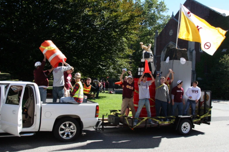 men in red and yellow life jackets are riding on a white truck