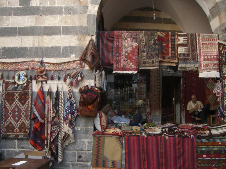 several rugs are on display under the doorway