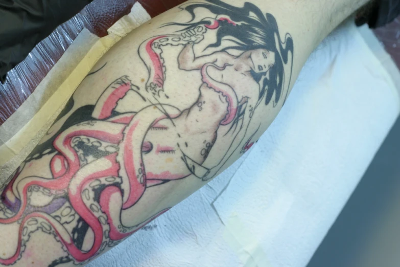 a black and pink tattoo of a woman