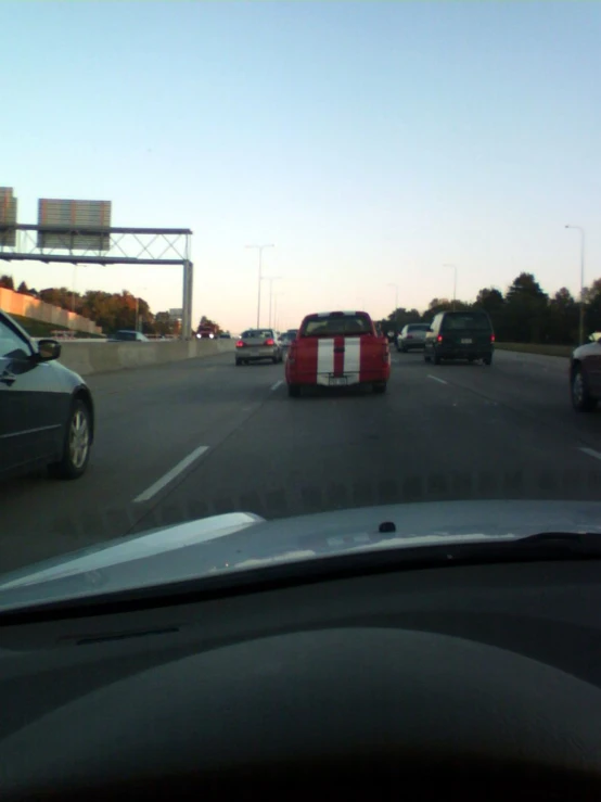 two cars are driving in both directions on a freeway