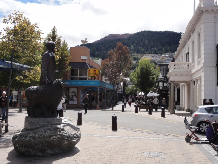 a man on horse - drawn cart going down a town street