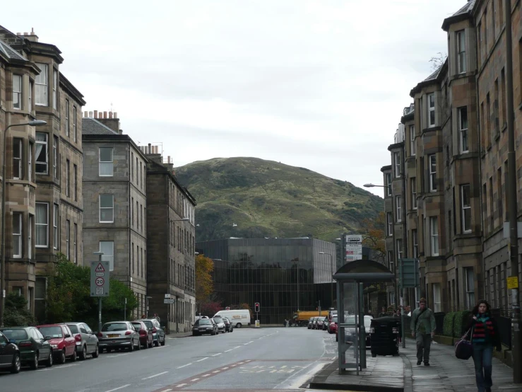 a very crowded city street with parked cars