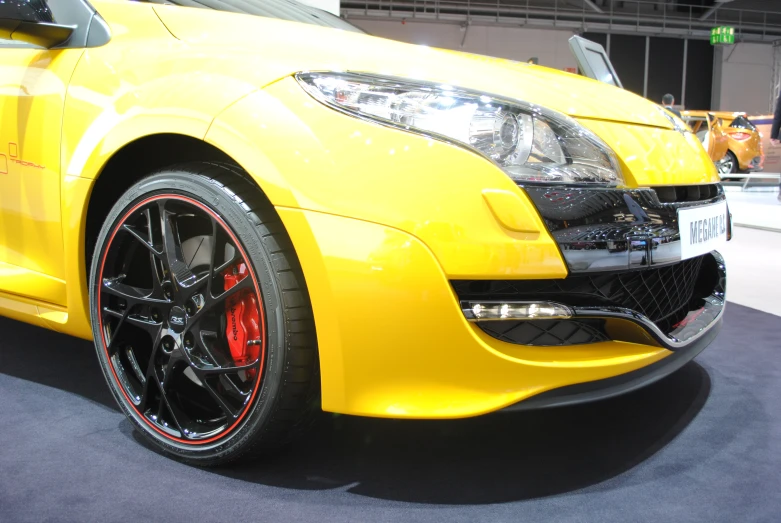 a yellow sports car on display for people to see