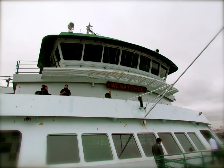 several people hanging out on the top deck of a boat