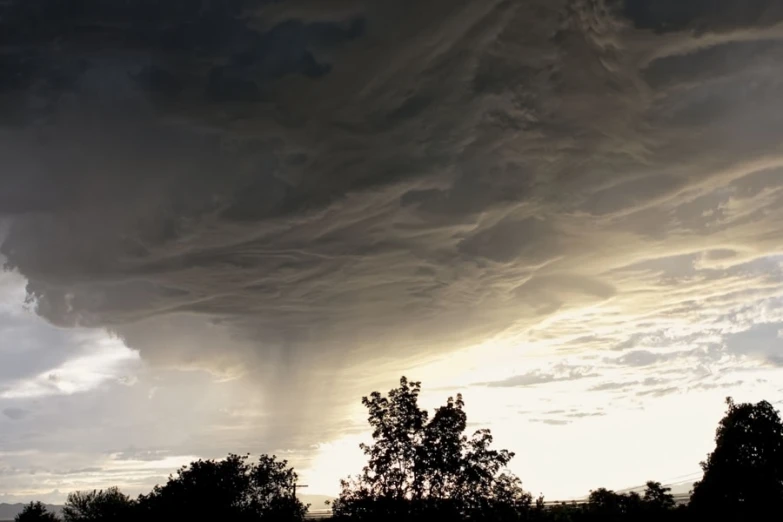 the weather is taking hold at sunset while a cloud rolls over