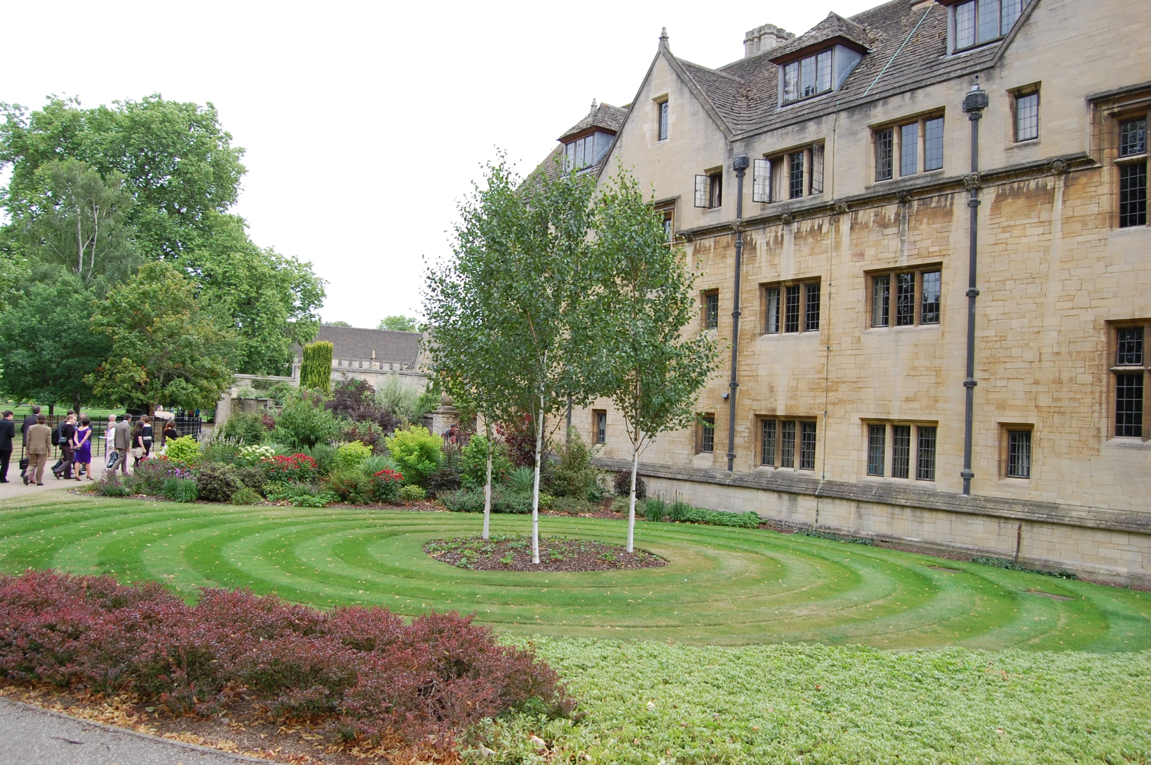 a very fancy lawn by an old building