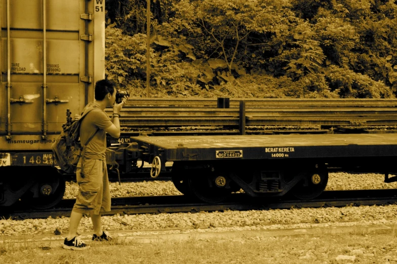 a man is standing next to a train car