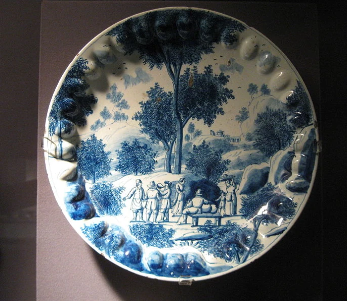 a blue and white plate is hanging on the wall