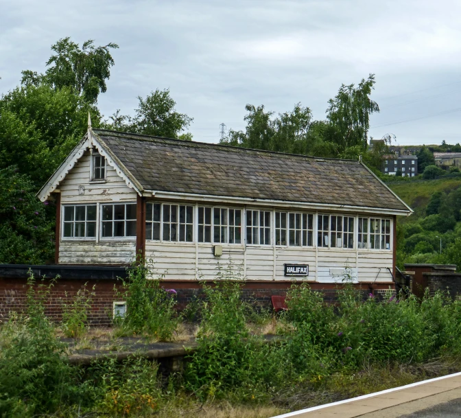 an old building with windows and shingled roof