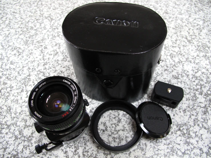 a camera with three lenses and an extension lens