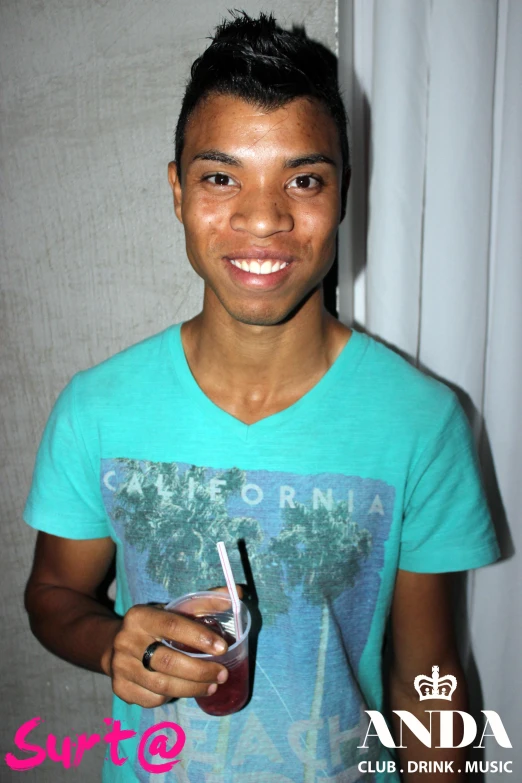 a young man holding a drink and a plastic wine glass