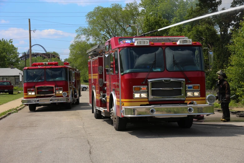 two large fire trucks parked at a fire station