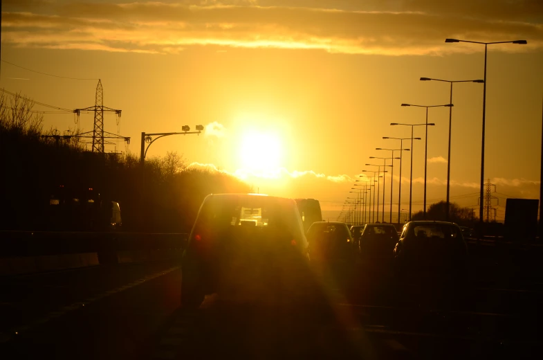 a sunset that has lights above a street