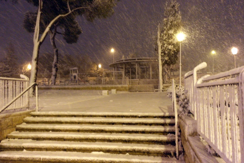 the snowy stairway in front of a gazebo is full of steps