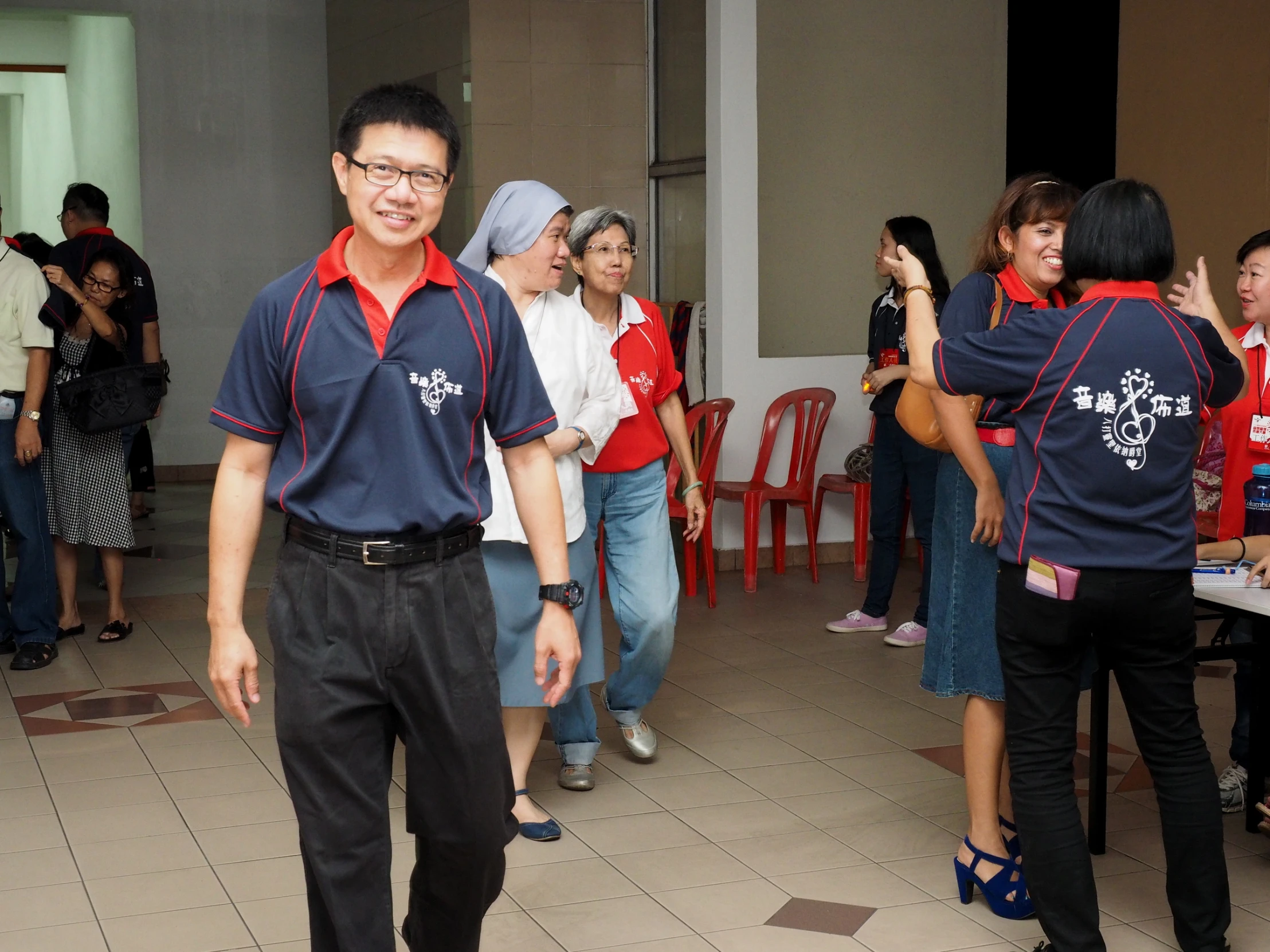 a young man is in the middle of a group of people