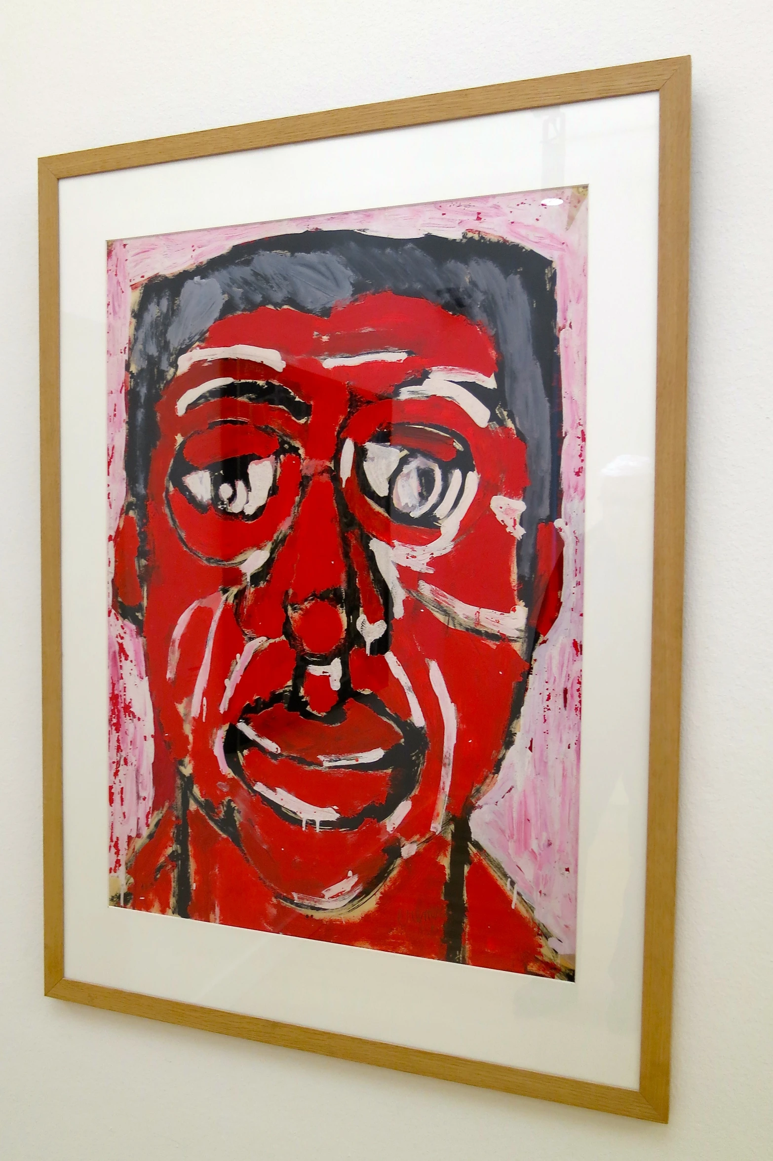 a red portrait is in a gold framed frame