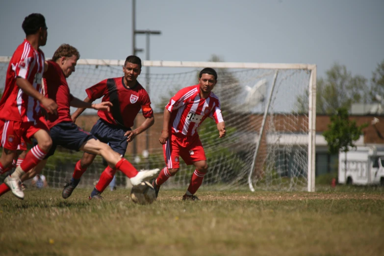 a group of men on a field playing soccer