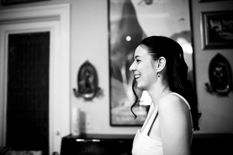 black and white pograph of a woman standing in front of a painting