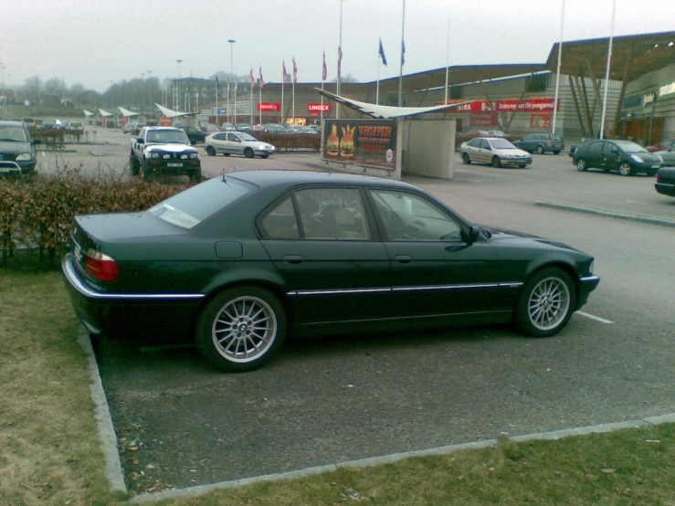 a bmw car sitting in the middle of a parking lot