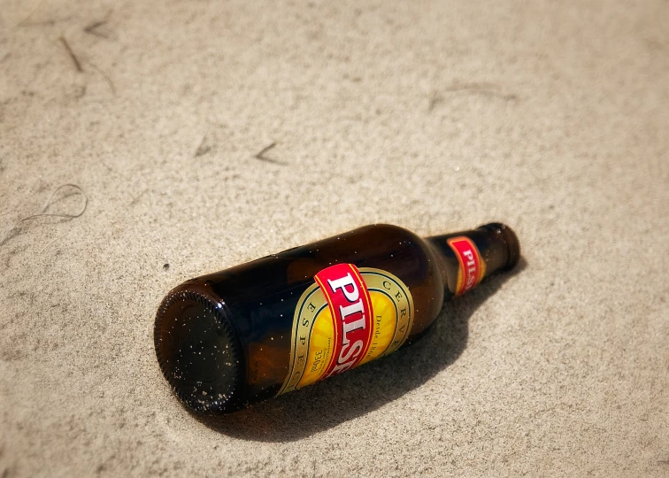 an empty beer bottle laying on the floor