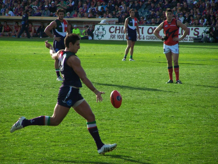 a male athlete playing soccer on the grass