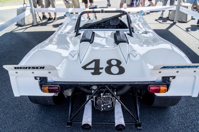 an old style race car with the number four on the back