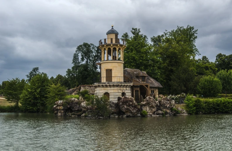 there is a small house on top of a rock outcropping