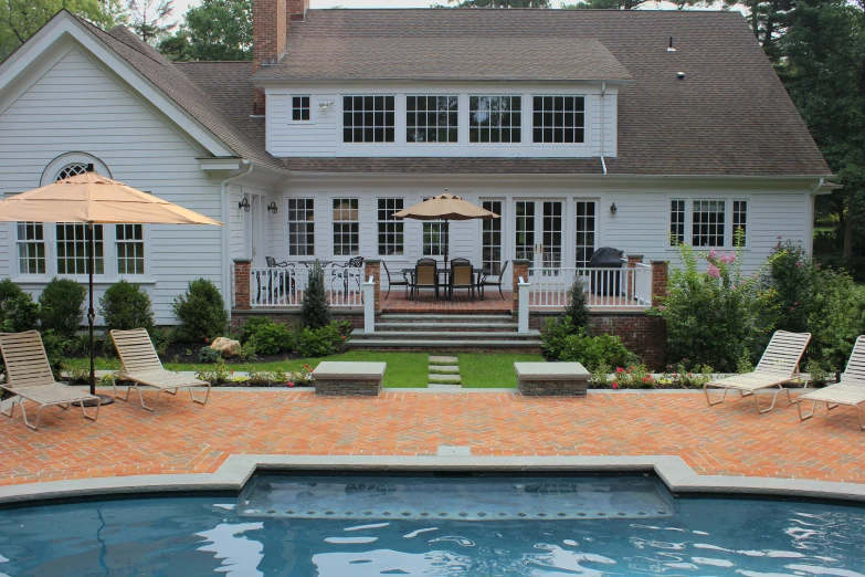 a white house with a patio and outdoor dining area