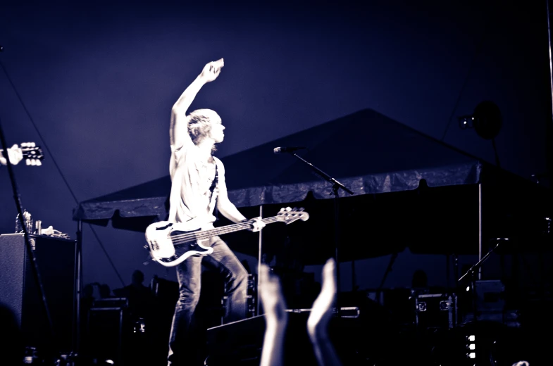 a person on a stage with a guitar