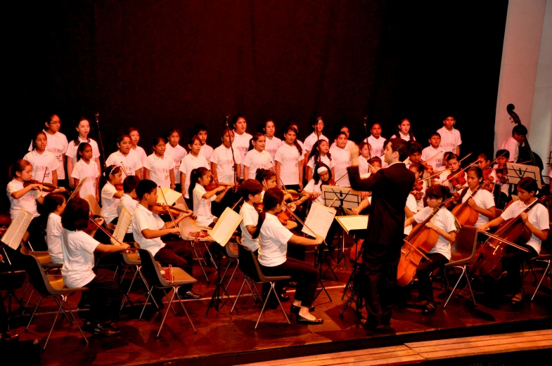 a group of people holding hands in front of a band