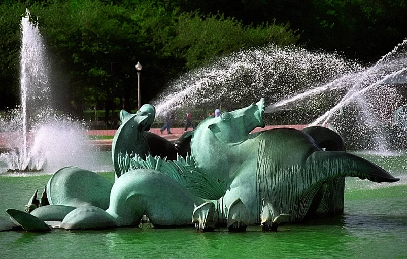 a large statue sitting in the middle of a lake