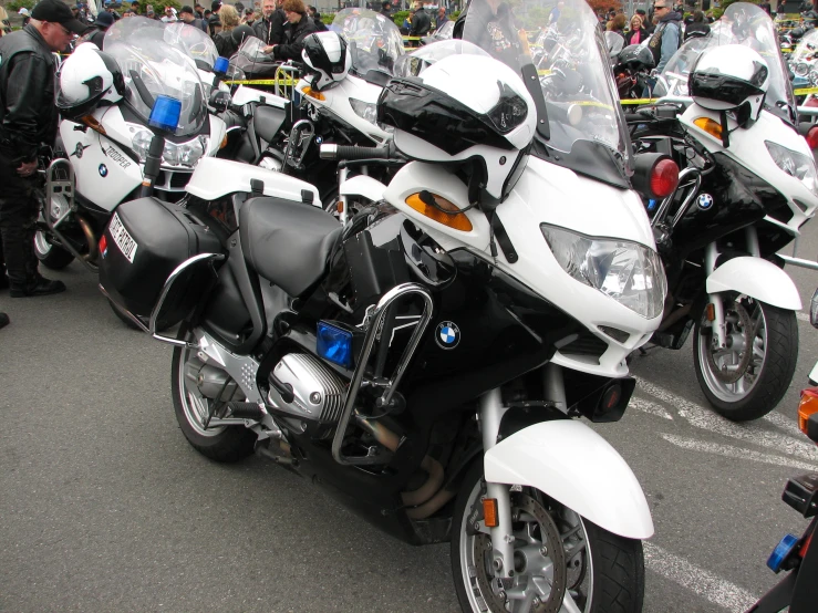 motorcycles are parked in a line on the pavement