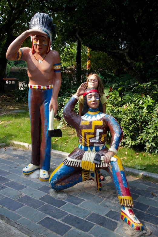 two statues of people dressed up as they are being pographed