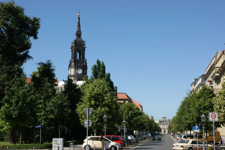 a clock tower on top of a church near a road