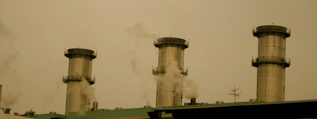 three smoke stacks, some with chimneys in the air