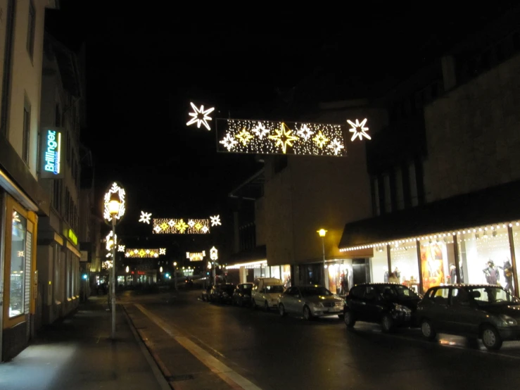 a night s of an older shopping district with lights