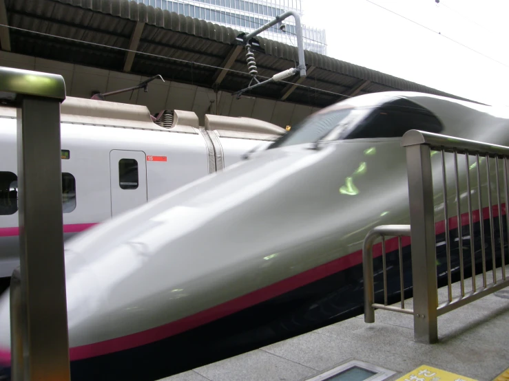 the large white train is approaching the station