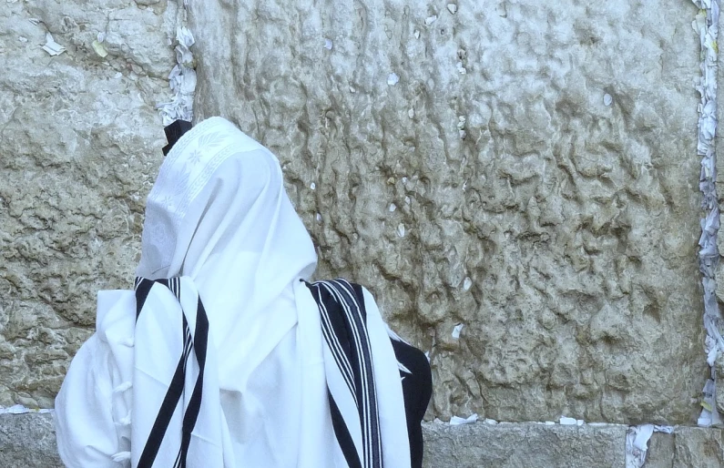 a woman walking in front of a wall