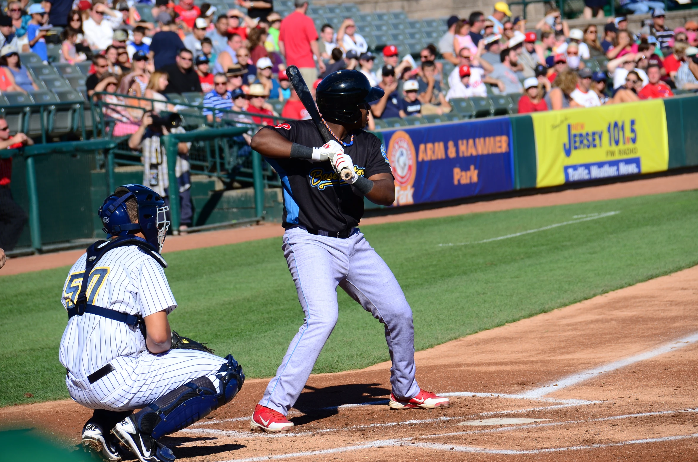 a baseball player is holding a bat at home plate