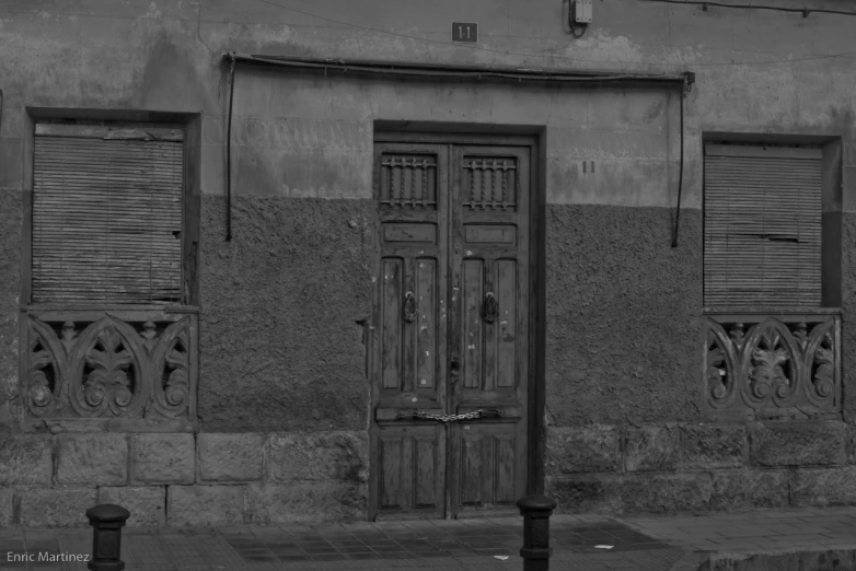 a building with shutters on it that are black and white