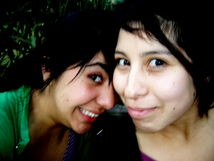 two young women smiling and taking a picture