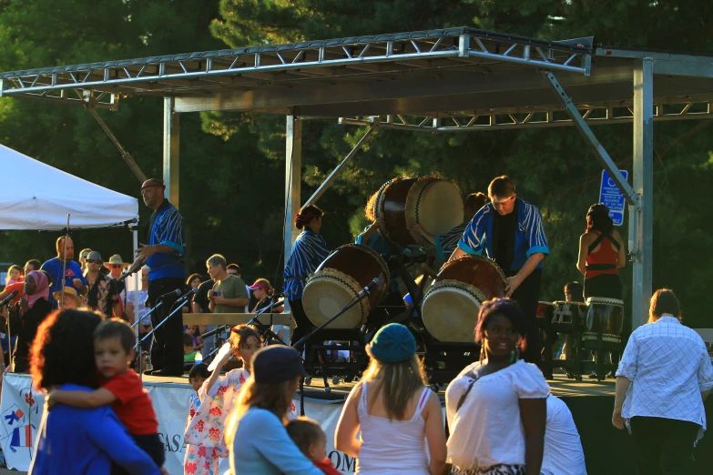 a band is performing at a concert in a park