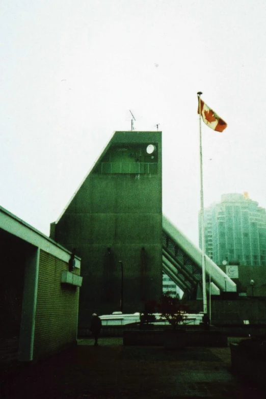 the american flag is flying on top of a tall building