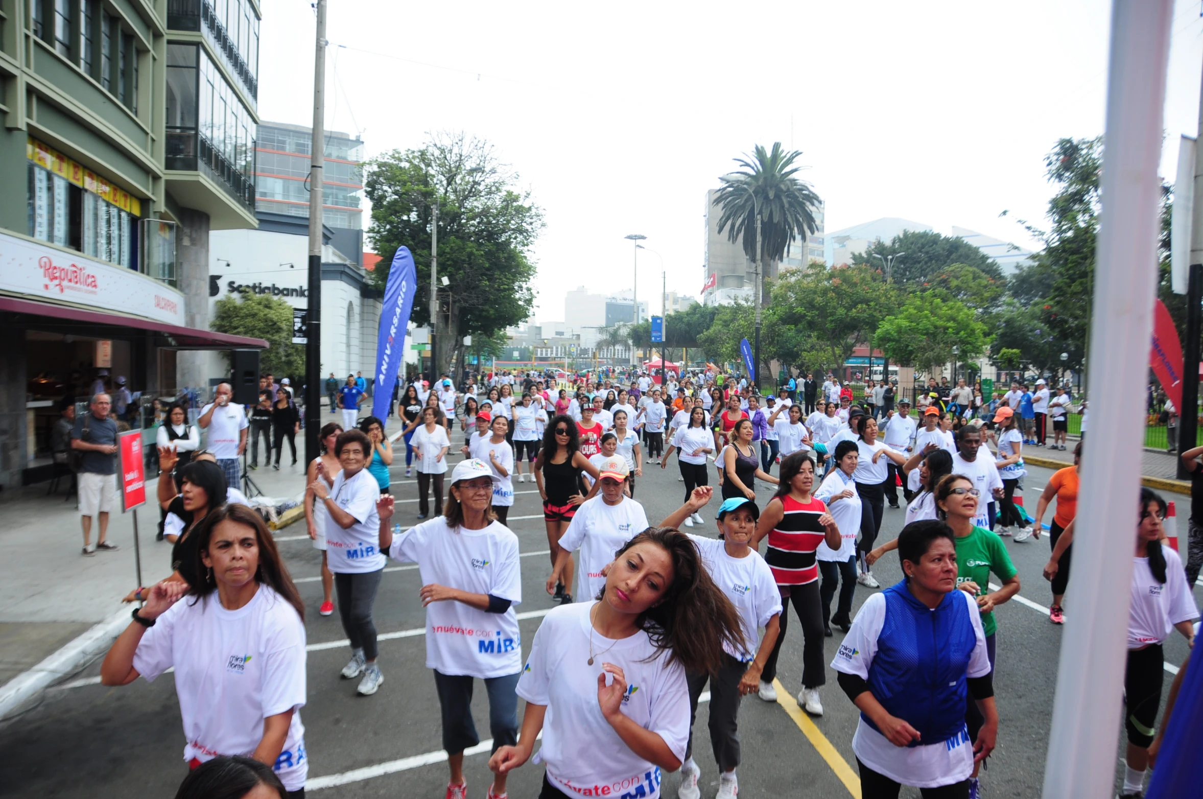 a large group of people walking down the street