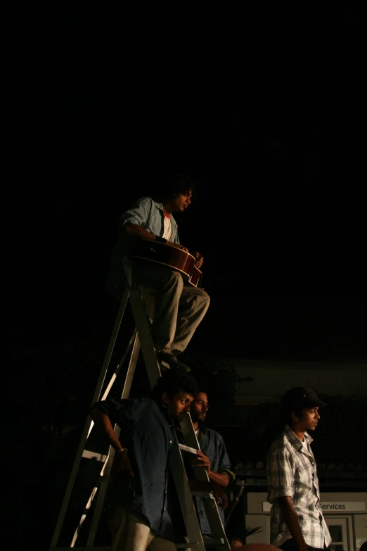 a group of men climbing on and down a ladder