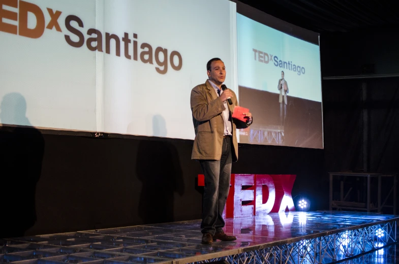 a man standing on a stage with a microphone