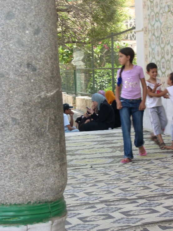 a number of people standing outside near one another