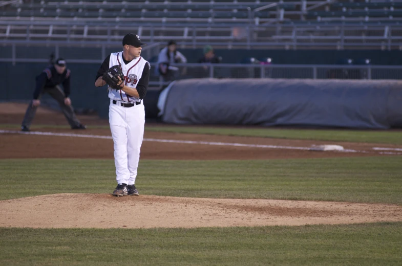 baseball pitcher standing on the mound in the middle of play