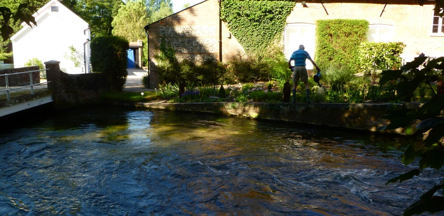 a man standing on a bridge over a river