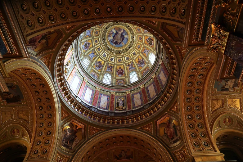 the ceiling of a fancy cathedral with mosaic patterns